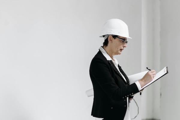 A Female Realtor Doing an Assessment